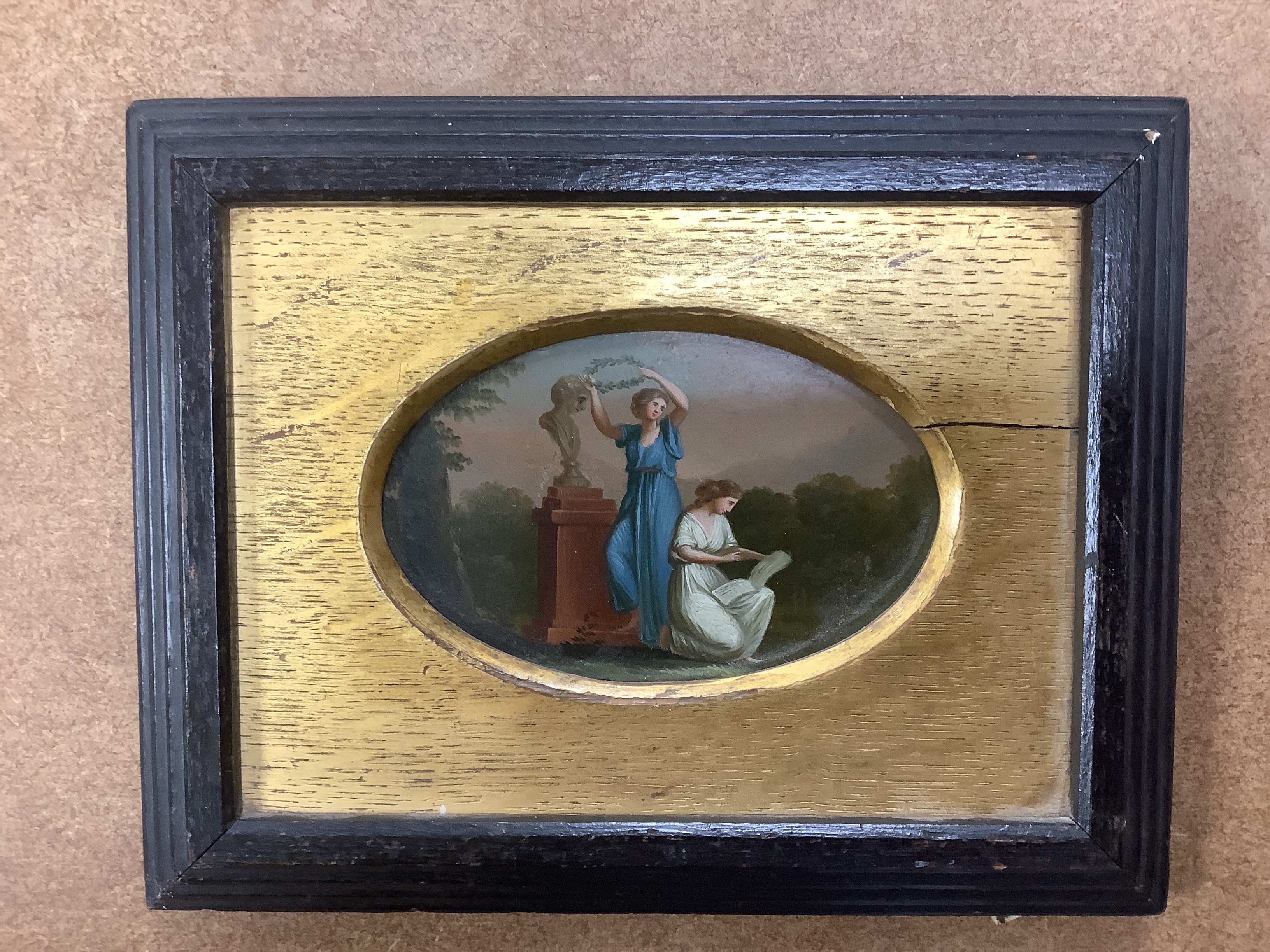 A pair of framed Sevres style porcelain oval plaques and a papier mache panel, inscribed verso and dated 1797, pair 26cm x 18cm